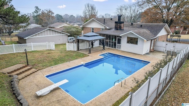 view of pool with a gazebo, a sunroom, a diving board, and a yard