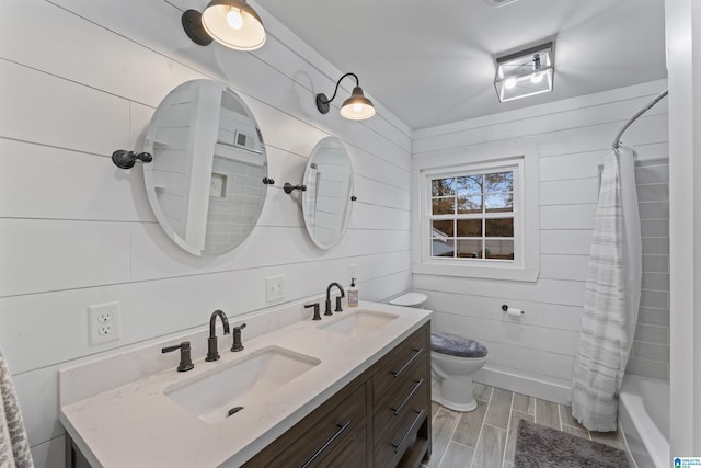 full bathroom featuring vanity, wood-type flooring, shower / bath combo, and wooden walls