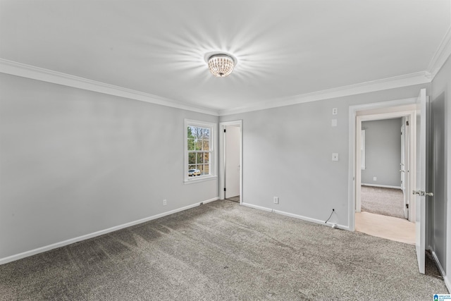 carpeted empty room featuring crown molding