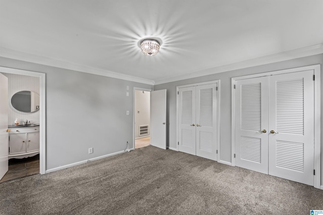 unfurnished bedroom with carpet, ornamental molding, and ensuite bath