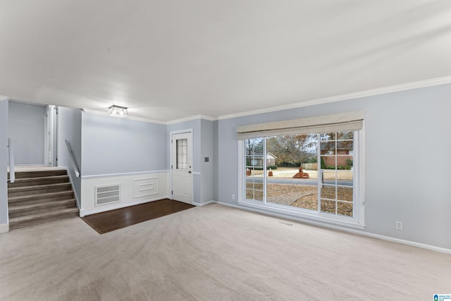 carpeted empty room featuring ornamental molding