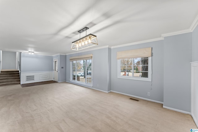 unfurnished living room with a wealth of natural light, light carpet, and ornamental molding