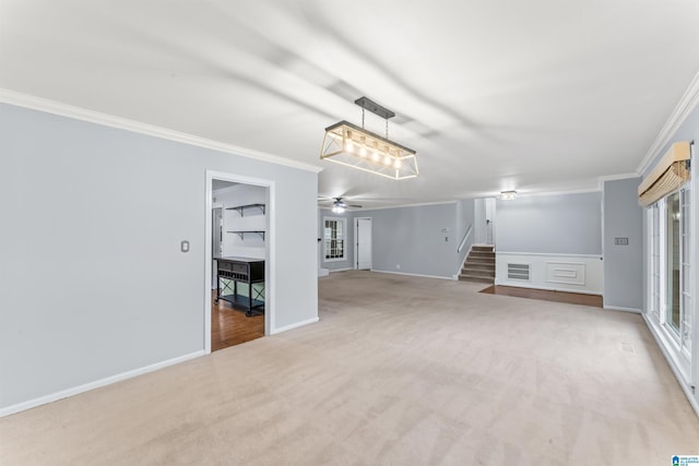 unfurnished living room featuring ceiling fan, light colored carpet, and ornamental molding