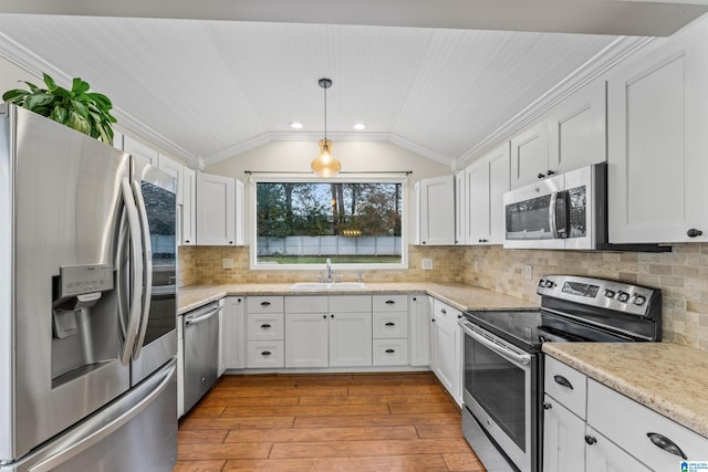 kitchen with white cabinetry, light hardwood / wood-style flooring, lofted ceiling, and appliances with stainless steel finishes