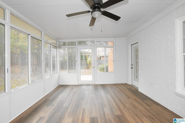 unfurnished sunroom featuring ceiling fan