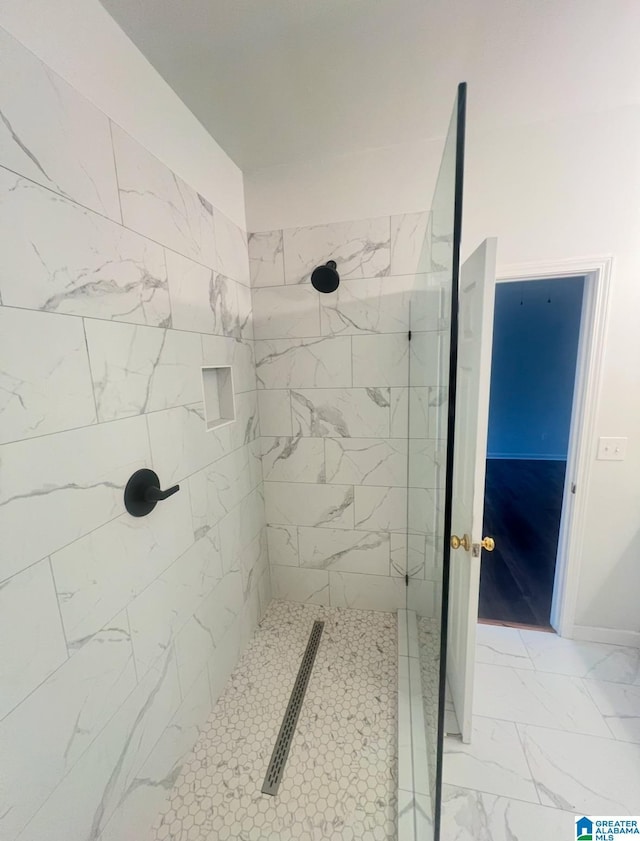 bathroom with a tile shower