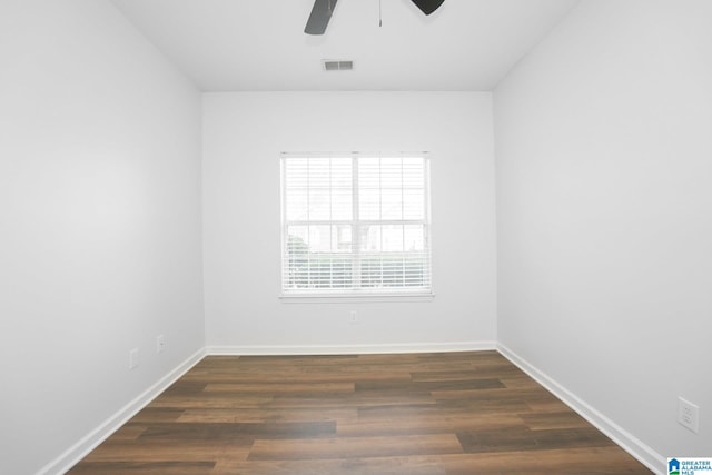 empty room with ceiling fan and dark wood-type flooring