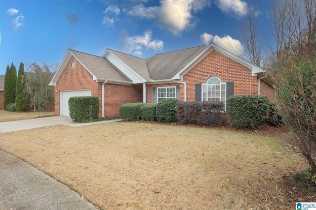 ranch-style home featuring a garage and a front yard