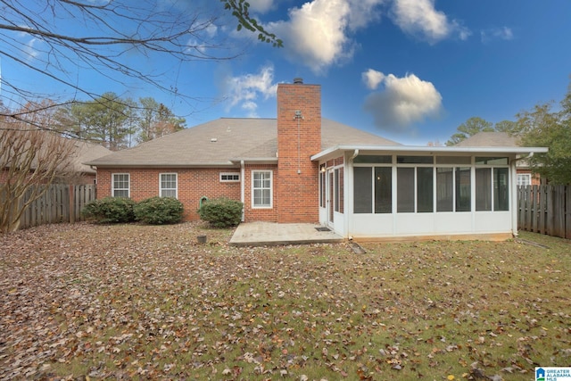 rear view of property featuring a patio area and a sunroom