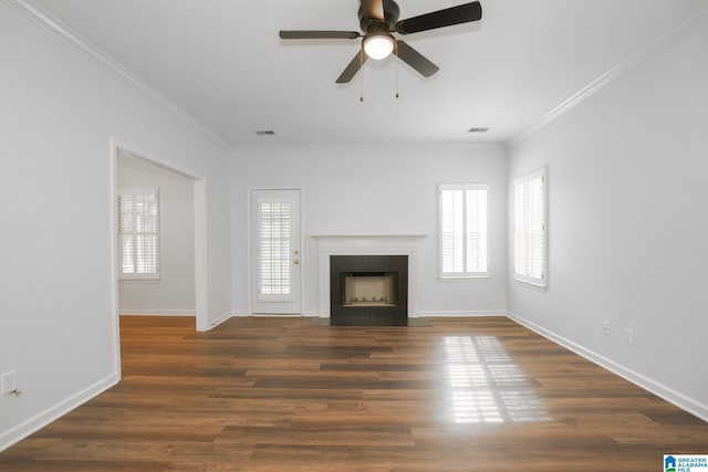 unfurnished living room with a fireplace, crown molding, dark hardwood / wood-style flooring, and ceiling fan