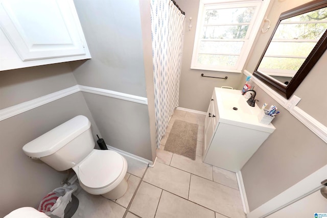 bathroom featuring tile patterned floors, vanity, and toilet