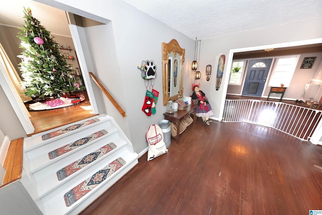 entrance foyer featuring a textured ceiling and dark hardwood / wood-style floors