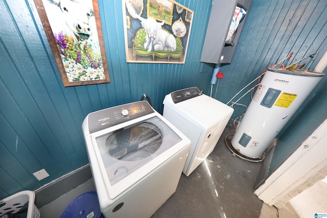 laundry area with separate washer and dryer, wooden walls, and water heater