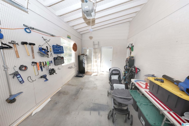 garage with a workshop area and a garage door opener