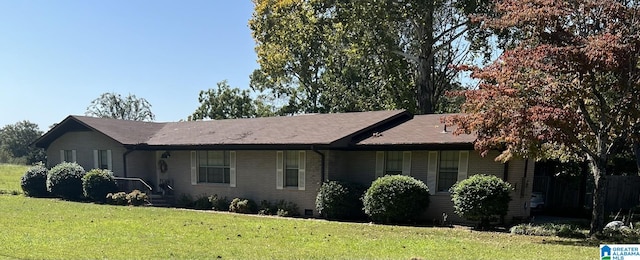 view of side of home with a yard