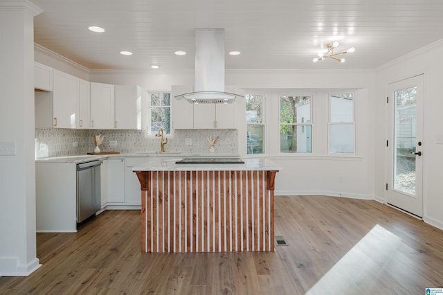 kitchen with island exhaust hood, a wealth of natural light, a kitchen island, and stainless steel dishwasher