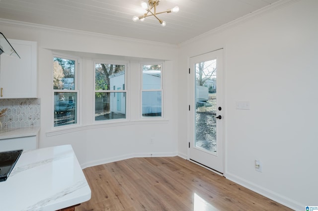 interior space featuring light hardwood / wood-style floors, a notable chandelier, and ornamental molding