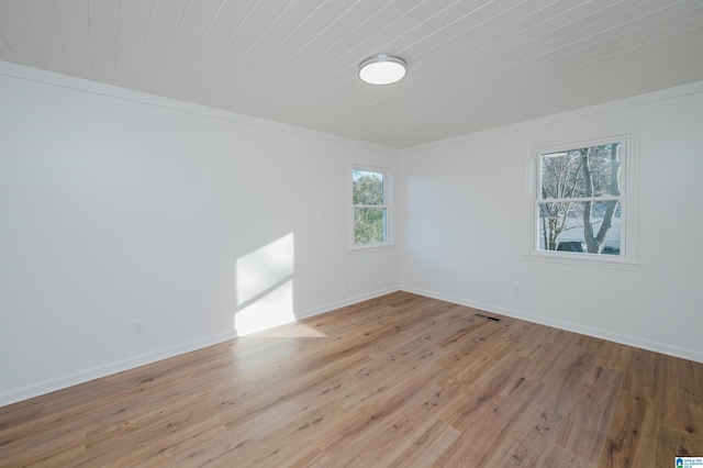 empty room with light hardwood / wood-style flooring and ornamental molding