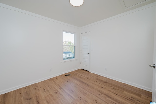 unfurnished room with light hardwood / wood-style flooring and ornamental molding