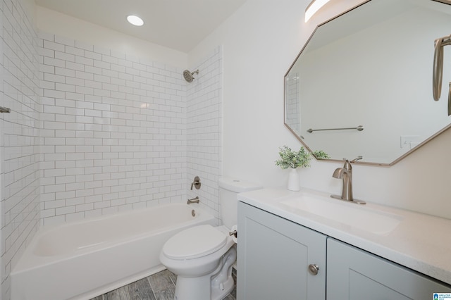 full bathroom featuring toilet, vanity, tiled shower / bath combo, and hardwood / wood-style flooring