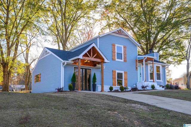 view of property featuring a front lawn