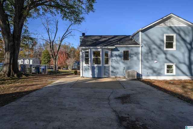 rear view of property featuring central AC