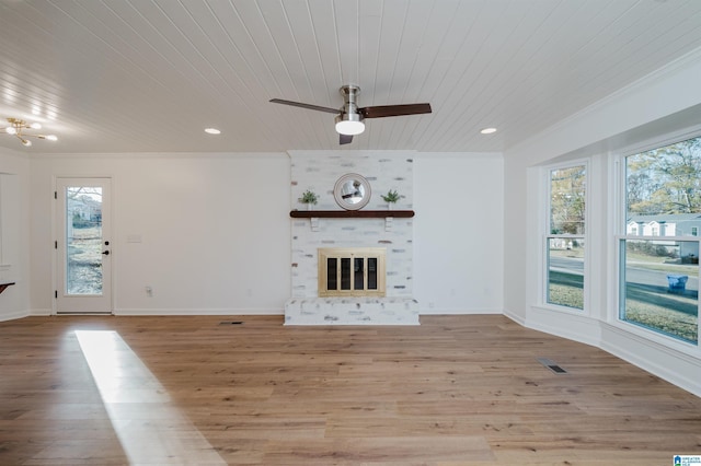 unfurnished living room with ornamental molding, a large fireplace, ceiling fan, wooden ceiling, and light hardwood / wood-style floors