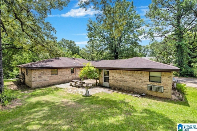 rear view of house with a patio area and a yard