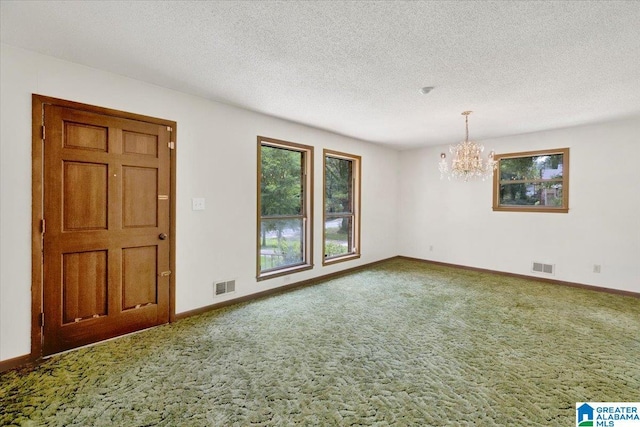 interior space with carpet flooring, a chandelier, and a textured ceiling