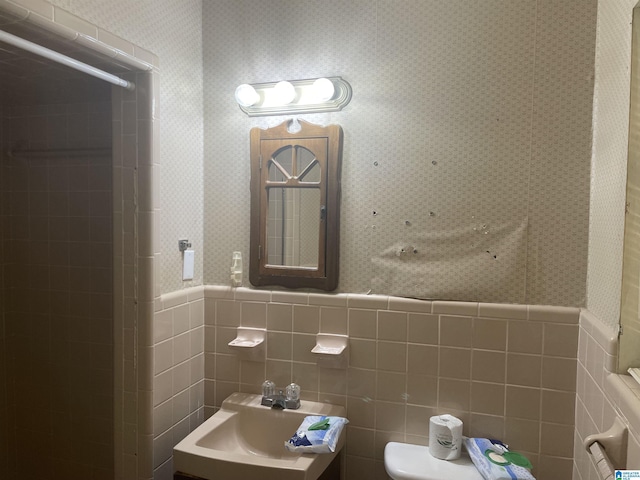 bathroom with vanity, tile walls, and toilet