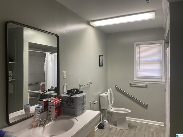 bathroom with vanity, wood-type flooring, and toilet