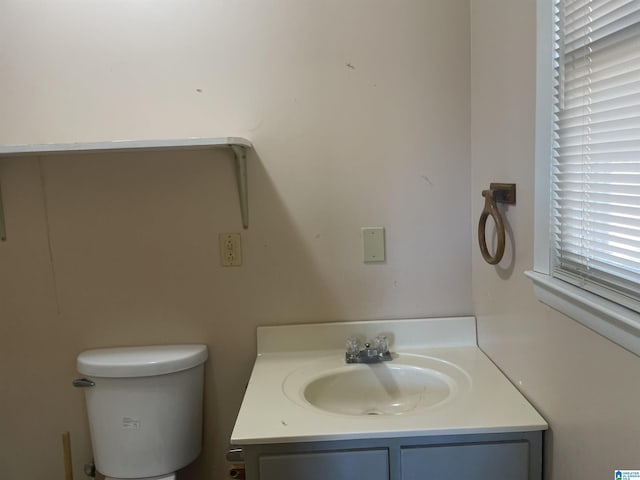 bathroom featuring vanity and toilet