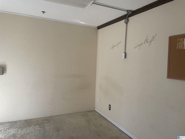 carpeted spare room with a textured ceiling