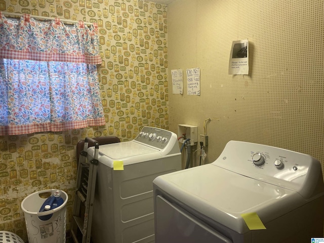 clothes washing area with independent washer and dryer