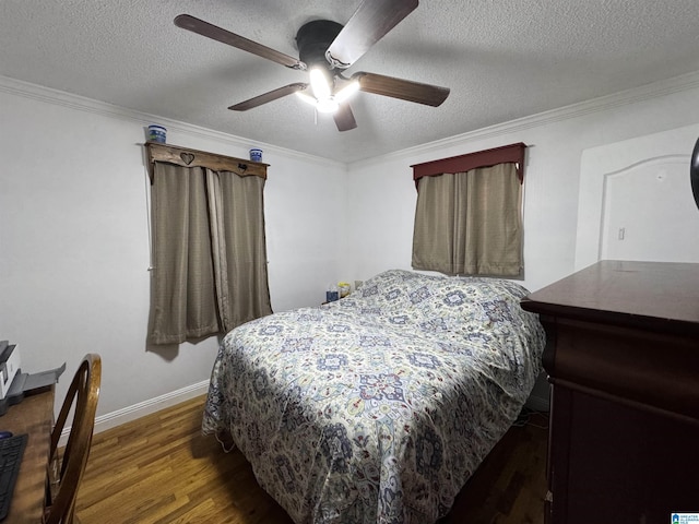 bedroom featuring a textured ceiling, dark hardwood / wood-style flooring, ceiling fan, and ornamental molding