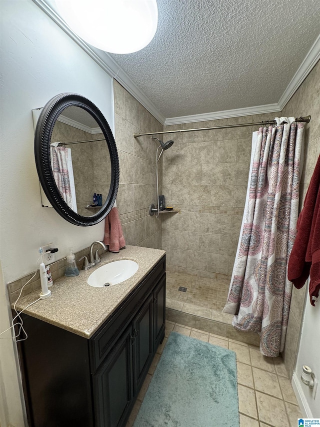 bathroom with vanity, tile patterned floors, crown molding, a textured ceiling, and curtained shower