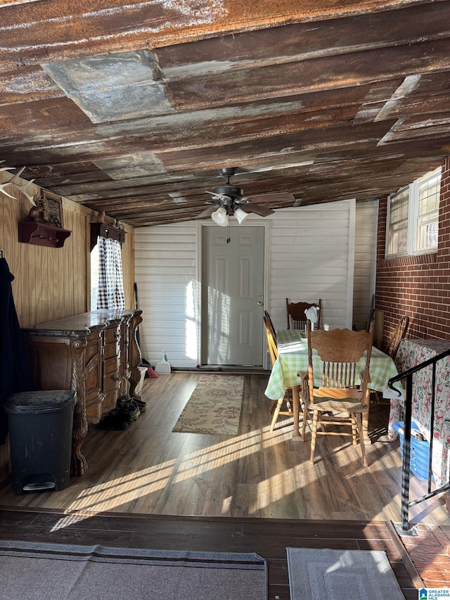 sunroom with ceiling fan and vaulted ceiling