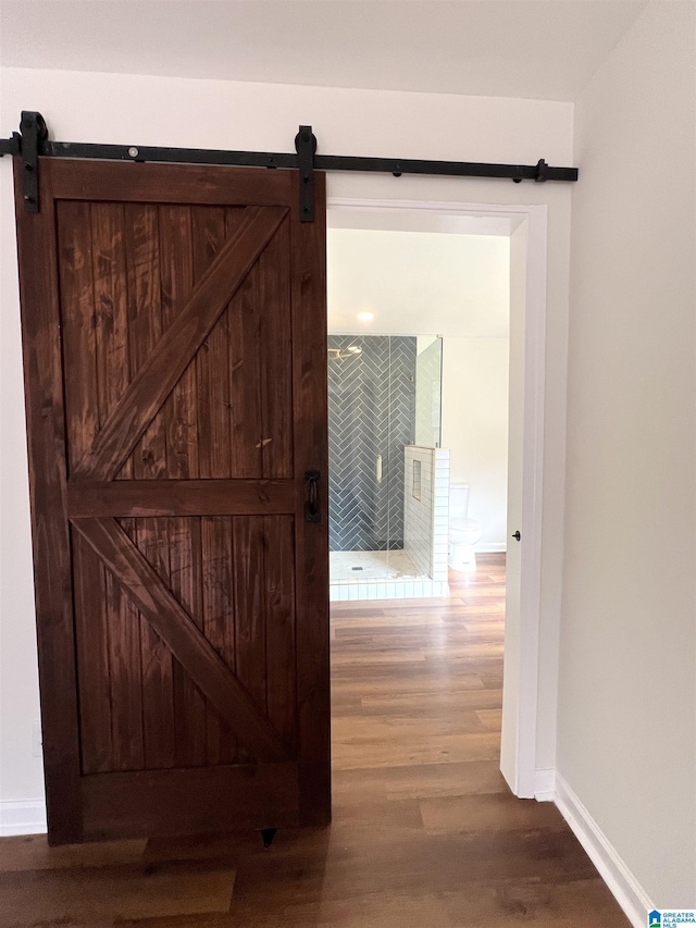 interior space featuring a barn door and hardwood / wood-style flooring