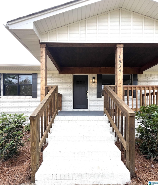 view of exterior entry featuring a porch