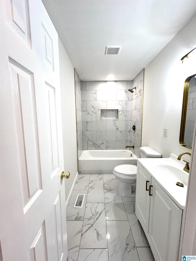 full bathroom featuring vanity, tiled shower / bath combo, and toilet