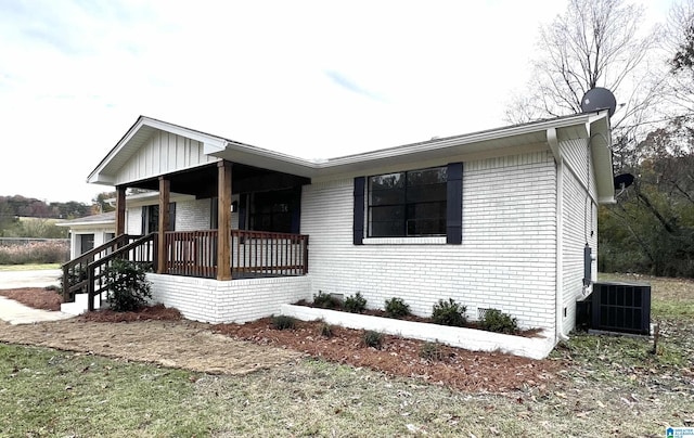 view of front of home featuring a porch and cooling unit