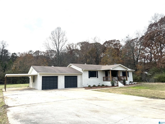 ranch-style home with a garage, a front yard, and a carport