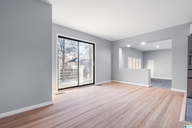 unfurnished room with light hardwood / wood-style flooring