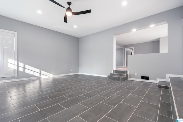 unfurnished living room with dark hardwood / wood-style floors and ceiling fan