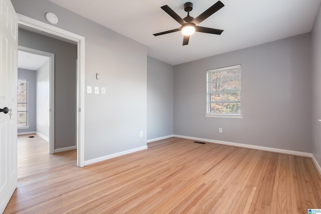 spare room featuring light hardwood / wood-style flooring and ceiling fan