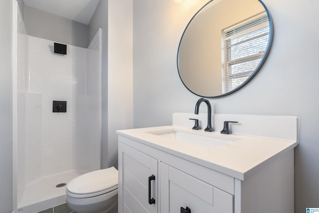 bathroom with a shower, vanity, and toilet