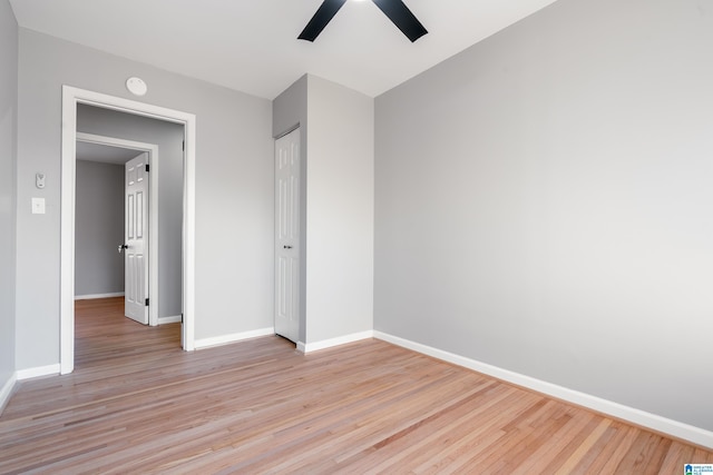 unfurnished bedroom with ceiling fan, a closet, and light hardwood / wood-style flooring