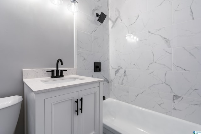 full bathroom with vanity, tiled shower / bath combo, and toilet