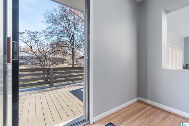 entryway with hardwood / wood-style floors and a healthy amount of sunlight