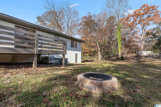 view of yard with a fire pit and a wooden deck